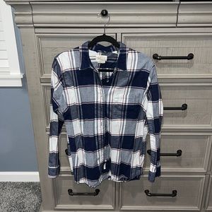 Blue, white and red striped flannel. Size XL but fits more like a L.